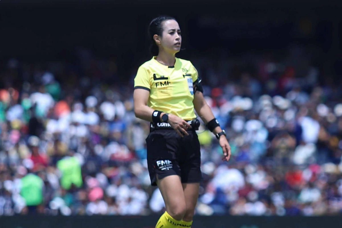 Katia Itzel usando uniforme de árbitro color amarillo con short negro 