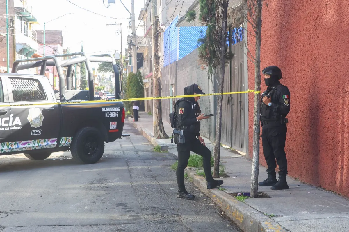 Agentes de la Policía SSC custodiando una zona acordonada junto a una patrulla durante un operativo de seguridad en la vía pública.