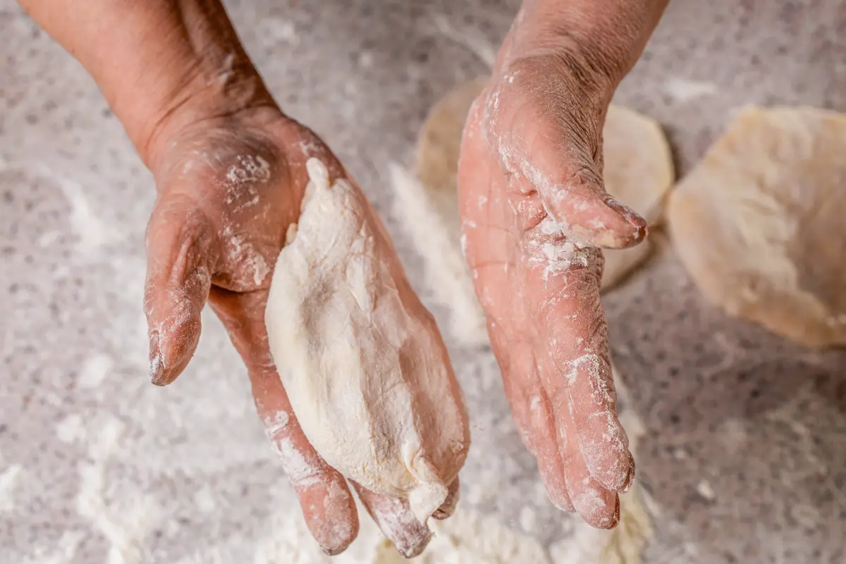 Manos amasando tortillas de harina